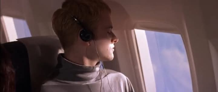 the main guy from the movie hackers on an aeroplane, closing his eyes and listening to his lil personal cassette player. 