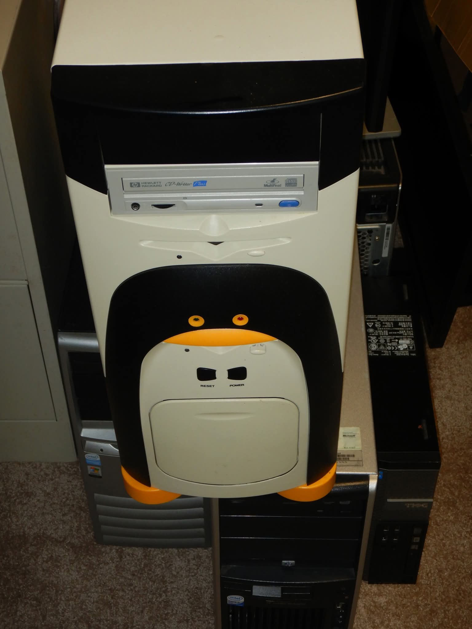 An old 2000s era beige PC with tux penguin colourings.