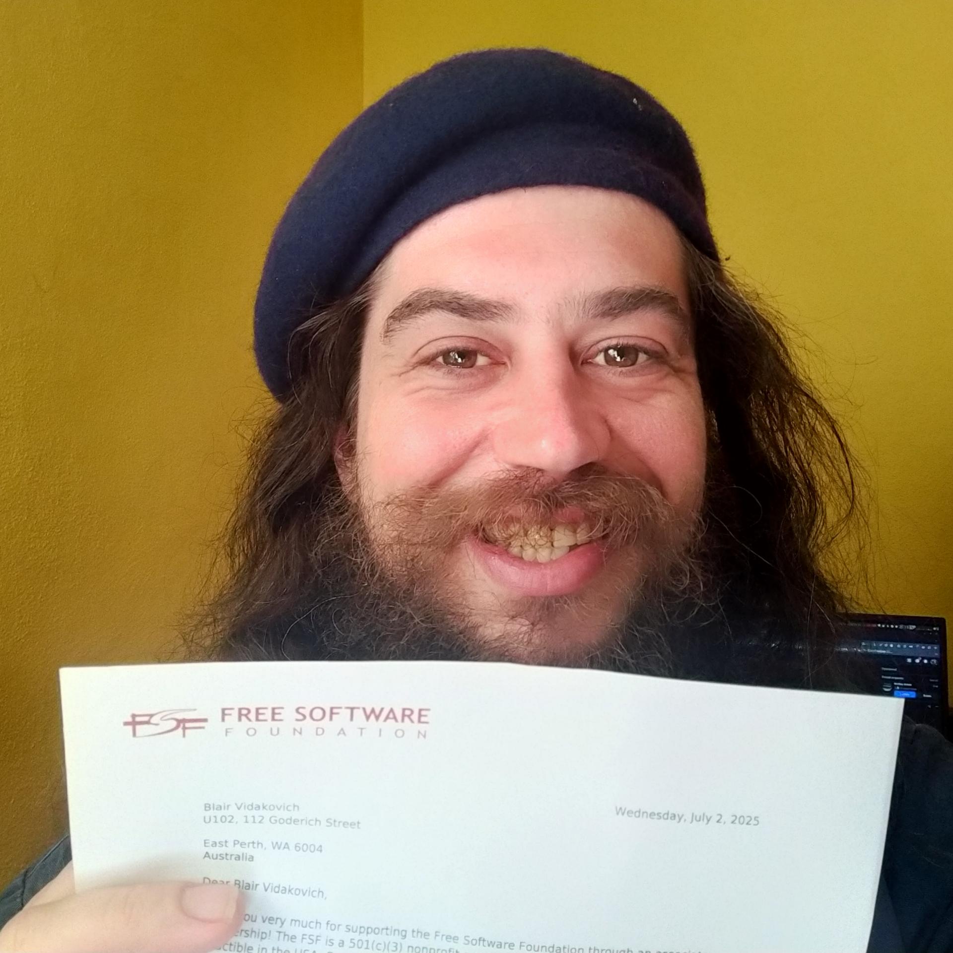 Vidak holding his membership letter.
